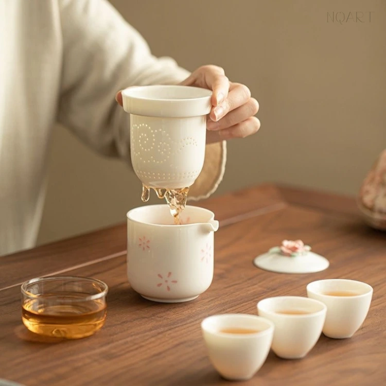 The strainer comes up out of the brewing cup with the tea still dripping from it — one lift, and the brewing is finished.