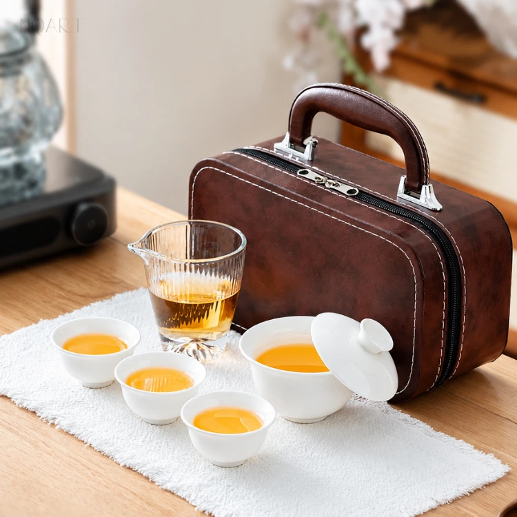 The complete portable tea set stood open on the table, case closed behind it, the whole gongfu tea set covering one straight line.