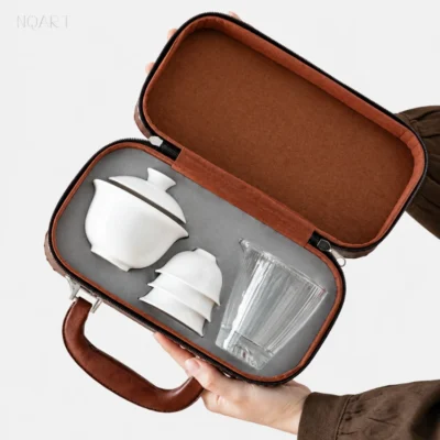 With the portable tea set with case open, the inside shows grey velvet and a recess shaped for the gaiwan, the cups and the pitcher.