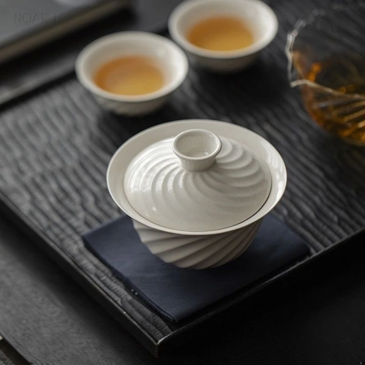 Straight down onto the lid, this tea set for picnics shows its pattern at full strength — fluting radiating from the knob, the same twist repeated on both cups.