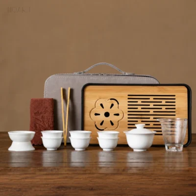 Same table, the other case colour — a tea set gift in grey, with the slatted tea tray and the rust tea towel in front of it.