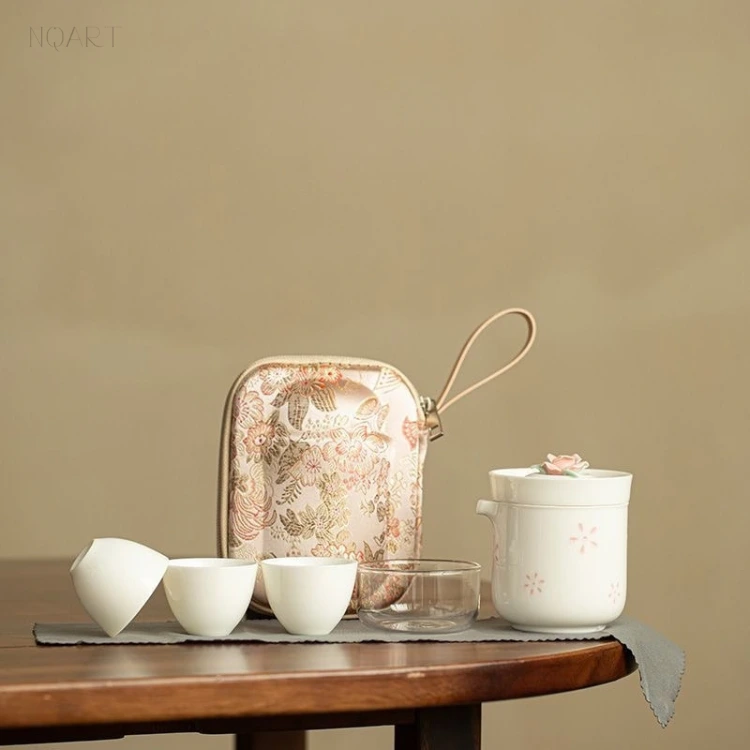 A unique tea gift for someone who drinks tea alone: the floral case stands behind the brewing cup, three cups and the glass, strap looped up.