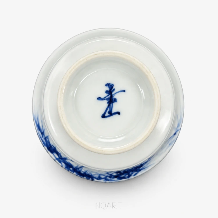 Looked at from below, the base shows the foot ring with a brush-written mark in underglaze blue at its centre.
