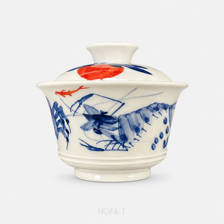 One blue crab holds the middle of this gaiwan, brushes of water plant around it and a small fish in underglaze red swimming past above.