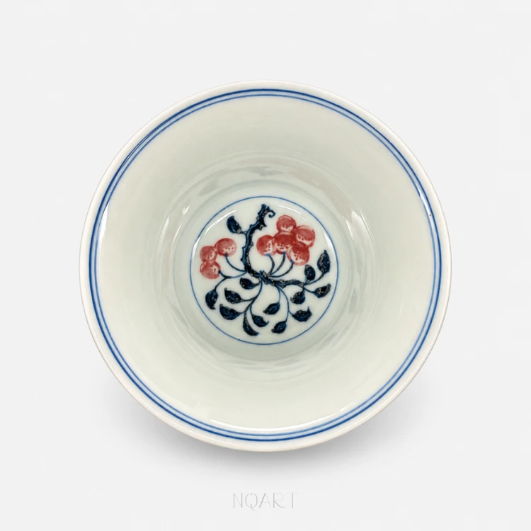 Inside there are only two blue lines at the rim and, at the bottom, a blue ring holding one branch of pomegranates.