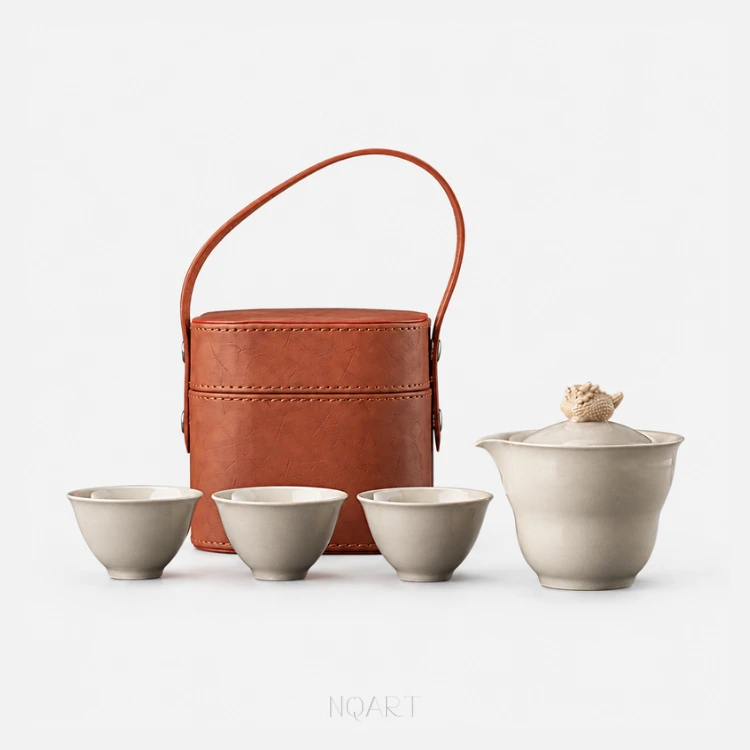 Everything the bucket holds, against white: a gaiwan tea set — the spouted bowl with its covered lid, three cups in a row, and the brown case standing behind them.