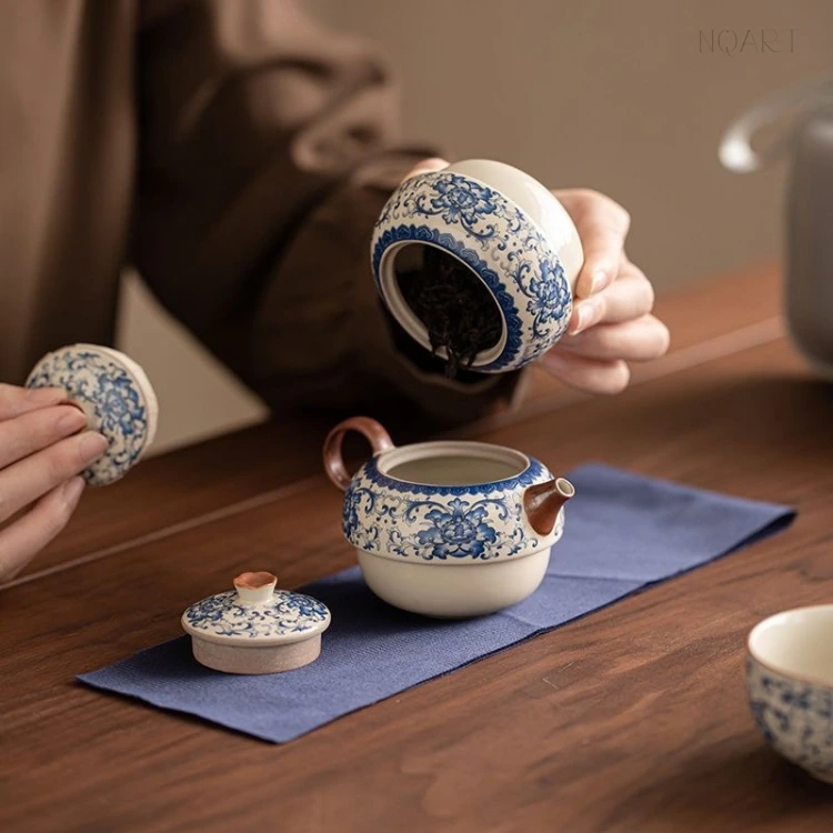 From the jar straight into the pot, the porcelain tea caddy drops its leaves without a scoop, the lid waiting in the other hand.