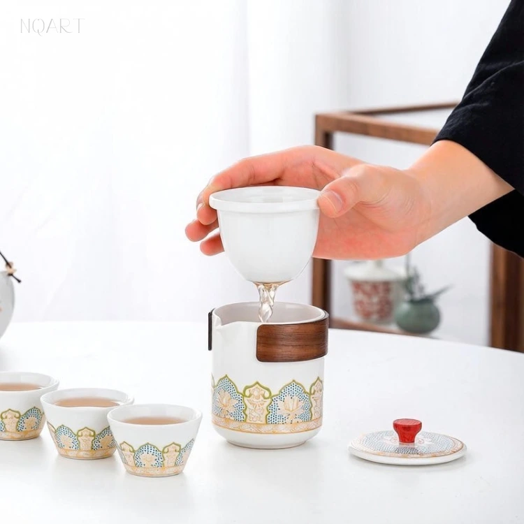 Held over the pot, the tea infuser basket lets the last of the tea through the holes in its floor before it is set aside.