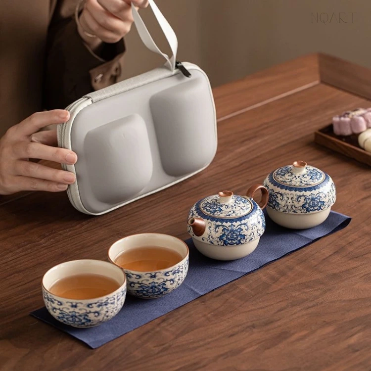 Set along the blue cloth, this tea set for two runs pot, cups, caddy in one line, with the case carried off above it.