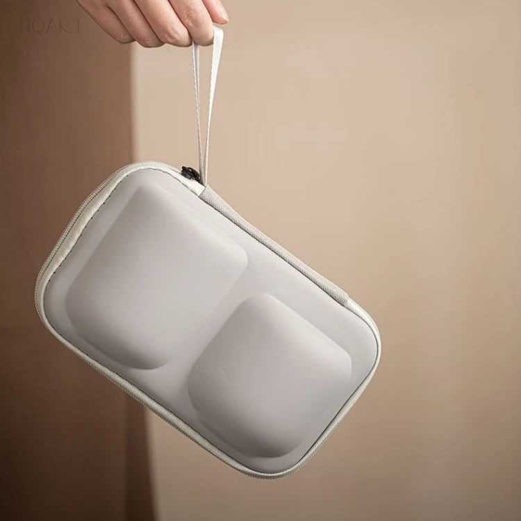 Swung up on its strap, the case shows the two moulded domes on its outside — for a tea set for van life, everything travels as one closed block.